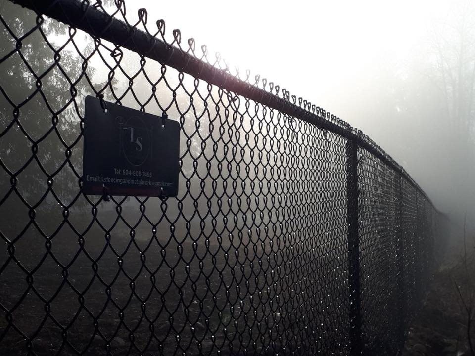 Black chain-link fence with top rail in Mission — LS Fencing & Metal Work archive photograph